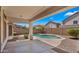 Enjoy a spacious back patio overlooking a stunning pool and manicured landscaping, ideal for outdoor living at 10046 E Posada Ave, Mesa, AZ 85212