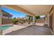 Relaxing back patio with beautiful landscaping and a refreshing pool, perfect for outdoor entertaining at 10046 E Posada Ave, Mesa, AZ 85212