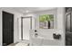 Bright bathroom featuring a soaking tub, a glass-enclosed shower, and a window overlooking greenery at 10046 E Posada Ave, Mesa, AZ 85212