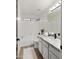 Bright bathroom featuring a shower-tub combo, granite counters, black hardware, and luxury vinyl plank flooring at 10046 E Posada Ave, Mesa, AZ 85212