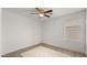 Bright bedroom with luxury vinyl plank flooring, ceiling fan, and a large window at 10046 E Posada Ave, Mesa, AZ 85212