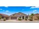 Well-kept single-Gathering home featuring desert landscaping, large driveway, and a two-car garage at 10046 E Posada Ave, Mesa, AZ 85212