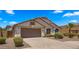 Charming single-story home with a well-maintained yard, mature trees, and an attached garage at 10046 E Posada Ave, Mesa, AZ 85212