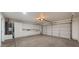 Spacious garage with wall storage, garage door, and concrete floor at 10046 E Posada Ave, Mesa, AZ 85212
