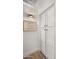 Hallway features a decorative wooden sign and built-in white storage cabinets with black hardware at 10046 E Posada Ave, Mesa, AZ 85212