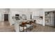 Modern kitchen with granite countertops, stainless steel appliances, and a stylish island with seating at 10046 E Posada Ave, Mesa, AZ 85212