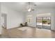 Bright living room with vaulted ceilings, hardwood floors, and a view of the backyard pool area at 10046 E Posada Ave, Mesa, AZ 85212
