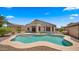 Inviting backyard oasis features a sparkling pool and covered patio, perfect for outdoor entertaining at 10046 E Posada Ave, Mesa, AZ 85212