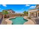 Inviting pool nestled in a private backyard oasis with lush landscaping and a covered patio at 10046 E Posada Ave, Mesa, AZ 85212