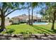Beautiful backyard with a sparkling pool, lush lawn, and mature trees providing shade at 10300 N 48Th Pl, Paradise Valley, AZ 85253