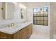Contemporary bathroom featuring a double sink vanity with white marble countertops and modern light fixtures at 10300 N 48Th Pl, Paradise Valley, AZ 85253