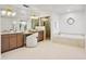 Spacious bathroom featuring a vanity, a tub, a shower, and a decorative window at 10300 N 48Th Pl, Paradise Valley, AZ 85253