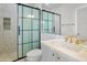 Modern bathroom with a sleek glass shower door, white tile walls, marble countertop, and gold faucet at 10300 N 48Th Pl, Paradise Valley, AZ 85253