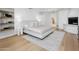 Spacious bedroom featuring wood floors, a fireplace, and a large bed with decorative pillows at 10300 N 48Th Pl, Paradise Valley, AZ 85253