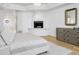 Bedroom featuring wood floors, a fireplace, a dresser, and neutral paint at 10300 N 48Th Pl, Paradise Valley, AZ 85253
