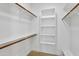 Walk-in closet featuring wood flooring, white walls, shelves, closet rods and provides plenty of space for storage at 10300 N 48Th Pl, Paradise Valley, AZ 85253