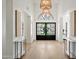 Bright foyer featuring a double-door entryway, marble tables, and a clear view of the front exterior at 10300 N 48Th Pl, Paradise Valley, AZ 85253