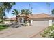 Spacious home with lush landscaping, a paver driveway, and an attached two-car garage at 10300 N 48Th Pl, Paradise Valley, AZ 85253