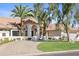 Beautiful single-story home showcasing lush landscaping, a circular driveway, and an elegant arched entryway at 10300 N 48Th Pl, Paradise Valley, AZ 85253