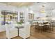 Bright eat-in kitchen with island seating flows into the living area with large windows at 10300 N 48Th Pl, Paradise Valley, AZ 85253
