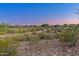 Scenic backyard with desert landscaping offering views of lush green fairways in a private and tranquil setting at 12809 W Oyer Ln, Peoria, AZ 85383