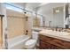 Traditional bathroom with decorative tile, shower over tub, and vanity with a mirror at 12809 W Oyer Ln, Peoria, AZ 85383
