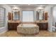 Luxurious primary bath with a soaking tub, double vanities, and tile flooring at 12809 W Oyer Ln, Peoria, AZ 85383