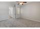 Neutral bedroom with a ceiling fan, carpet and natural light from the window at 12809 W Oyer Ln, Peoria, AZ 85383