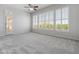 Bright bedroom with a ceiling fan and large windows with a door to the patio at 12809 W Oyer Ln, Peoria, AZ 85383