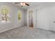 Bright, carpeted bedroom features arched windows and a closet for ample storage at 12809 W Oyer Ln, Peoria, AZ 85383