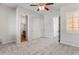 Spacious bedroom with plush carpeting and a ceiling fan, adjacent to the bathroom at 12809 W Oyer Ln, Peoria, AZ 85383