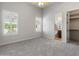 Bedroom with neutral walls, carpet flooring, and an ensuite bathroom at 12809 W Oyer Ln, Peoria, AZ 85383