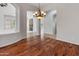 Dining room view of living spaces with chandelier lighting and hardwood floors at 12809 W Oyer Ln, Peoria, AZ 85383