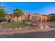 Charming single-story home featuring a tile roof, landscaped front yard, and a two-car garage, set against a twilight sky at 12809 W Oyer Ln, Peoria, AZ 85383