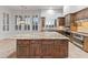 Bright kitchen features wooden cabinets, granite countertops, stainless steel appliances, and a large kitchen island at 12809 W Oyer Ln, Peoria, AZ 85383