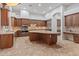 Gourmet kitchen featuring custom cabinets, a large island, granite countertops, and stainless steel appliances at 12809 W Oyer Ln, Peoria, AZ 85383