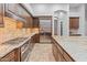 Well-equipped kitchen featuring custom cabinets, granite countertops, stainless steel appliances, and a center island at 12809 W Oyer Ln, Peoria, AZ 85383