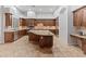 Spacious kitchen featuring granite countertops, custom cabinetry, stainless steel appliances, and tile floors at 12809 W Oyer Ln, Peoria, AZ 85383