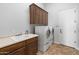 Laundry room with a utility sink, cabinets and front load washer and dryer at 12809 W Oyer Ln, Peoria, AZ 85383