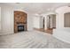 Inviting living room with stone fireplace, arched doorways, and neutral decor, offering a cozy and elegant atmosphere at 12809 W Oyer Ln, Peoria, AZ 85383