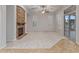 Open living room with fireplace, neutral carpet, ceiling fan, and sliding glass door to backyard at 12809 W Oyer Ln, Peoria, AZ 85383