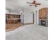 Open living space with stone fireplace and view of the kitchen at 12809 W Oyer Ln, Peoria, AZ 85383