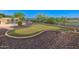 Backyard putting green complemented by desert landscaping, rocks, and drought-tolerant plantings at 12809 W Oyer Ln, Peoria, AZ 85383