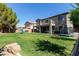 Expansive backyard with play equipment, mature trees, and an inviting patio area at 1342 E Jade Dr, Chandler, AZ 85286