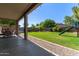 Covered patio and well-maintained backyard with green grass and a slide at 1342 E Jade Dr, Chandler, AZ 85286