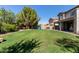 Spacious backyard featuring lush lawn, playset, outdoor grill, and patio seating at 1342 E Jade Dr, Chandler, AZ 85286