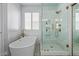 Elegant bathroom featuring a soaking tub, glass shower with rainfall showerhead, and custom tile work at 1342 E Jade Dr, Chandler, AZ 85286