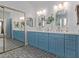 Bathroom featuring double vanity with blue cabinets, quartz countertop, gold fixtures and decorative tile floor at 1342 E Jade Dr, Chandler, AZ 85286