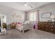 Cozy bedroom with a bed, dresser, and a mirror creating a comfortable personal space at 1342 E Jade Dr, Chandler, AZ 85286