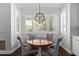 Cozy dining area with four chairs, shuttered windows and modern light fixture at 1342 E Jade Dr, Chandler, AZ 85286